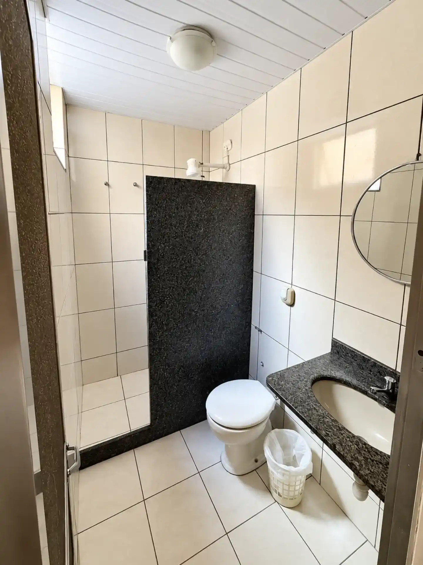 Private bathroom with shower, sink and mirror